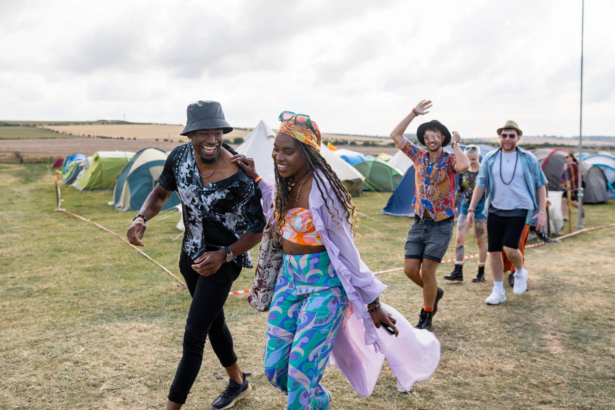 Festival attendees walking through an outdoor event site